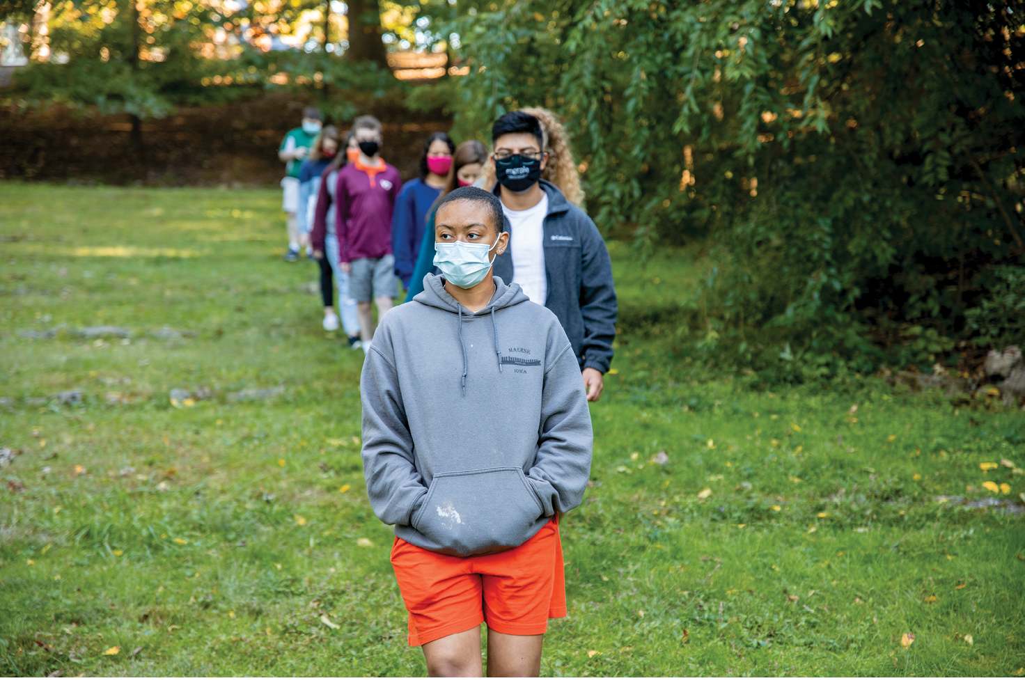 Image of Nia Salway walking at Duck Pond with line of students behind her